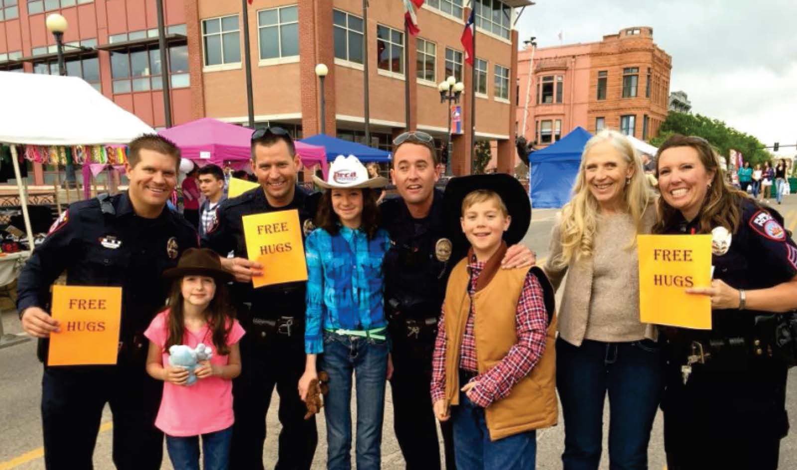 Group holding free hugs signs