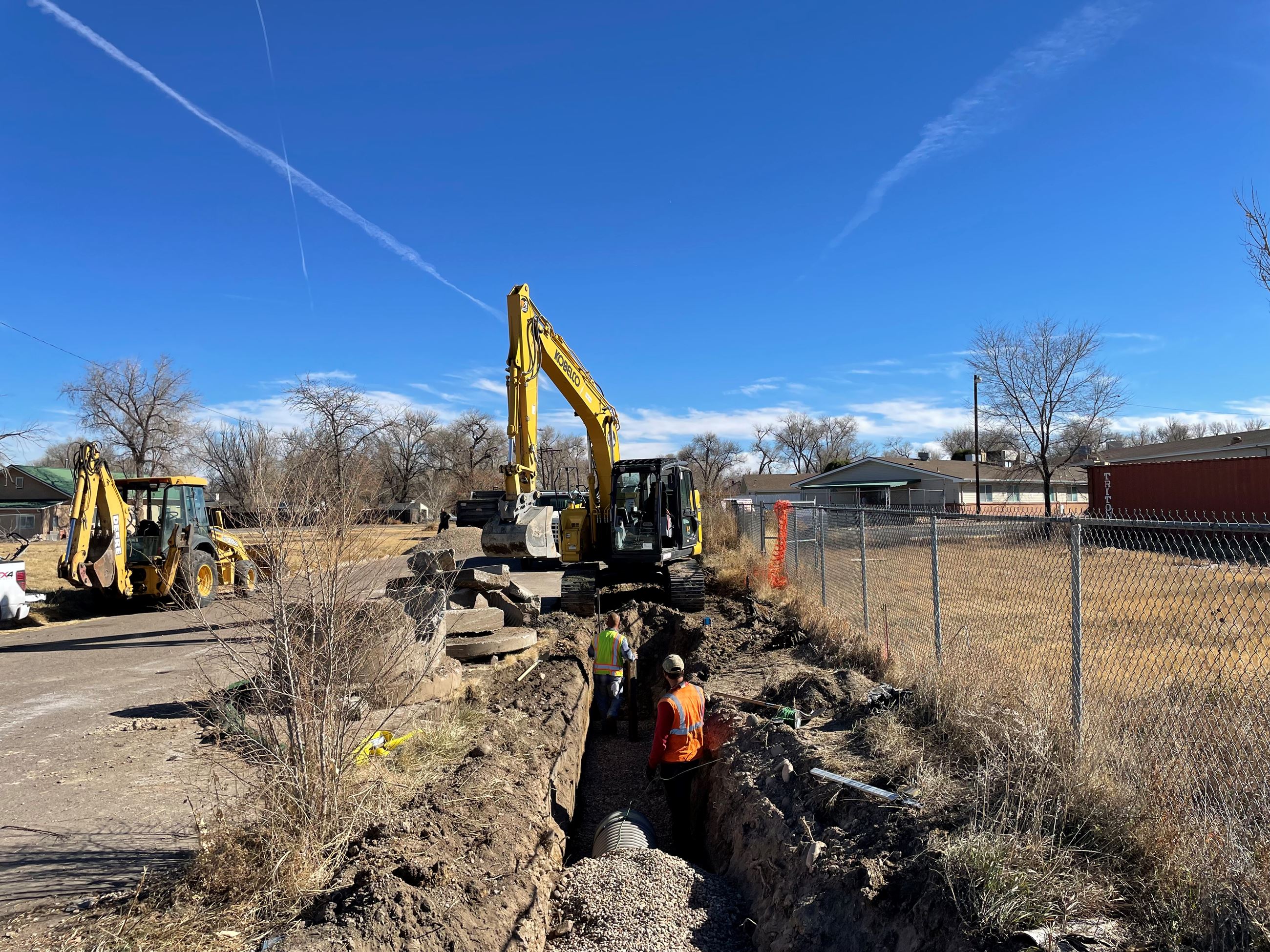 Trench dug with workers standing inside
